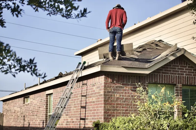 Professional roofer working on a residential roof in Pillow